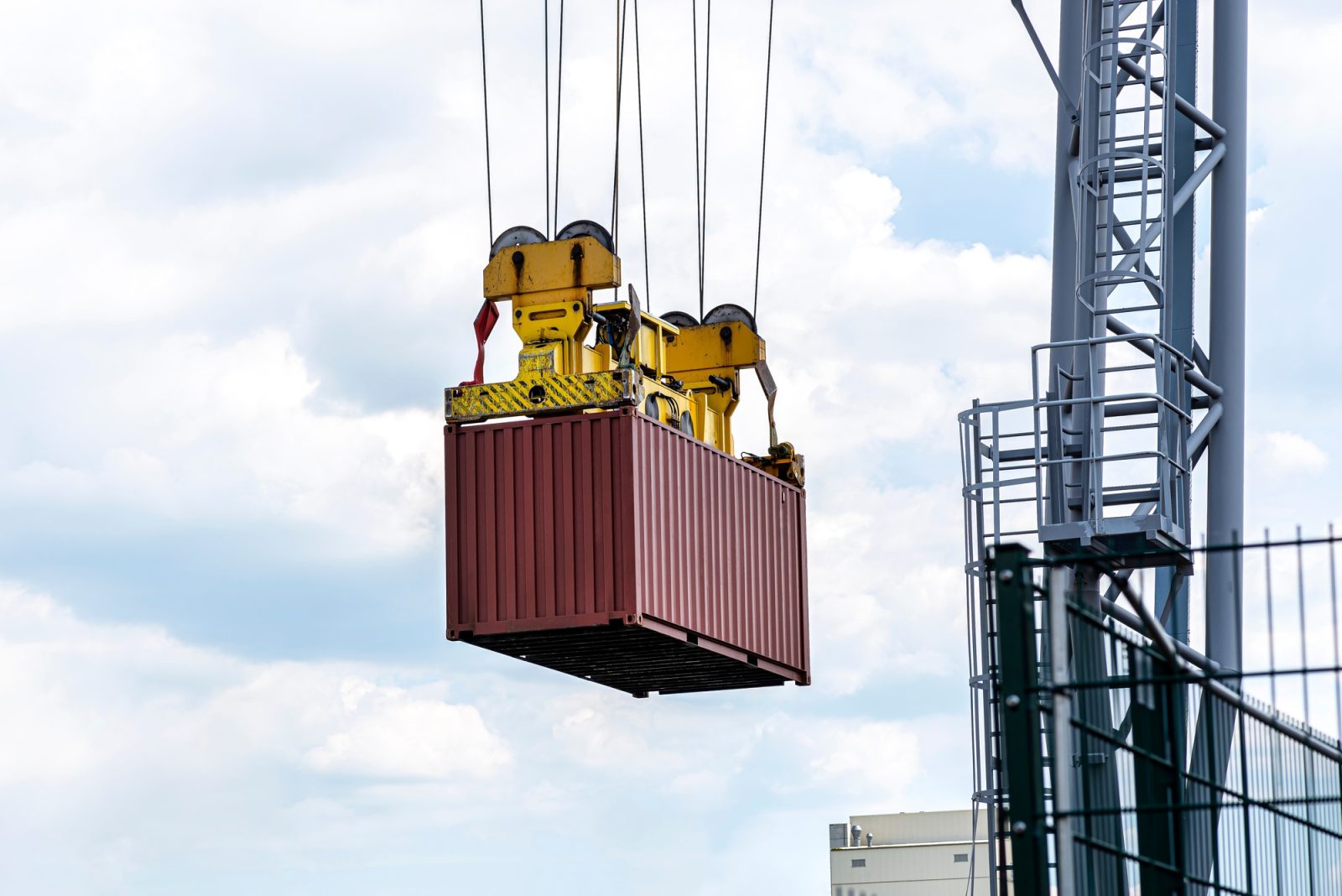 A container gantry crane on a rail loads the container into a barge