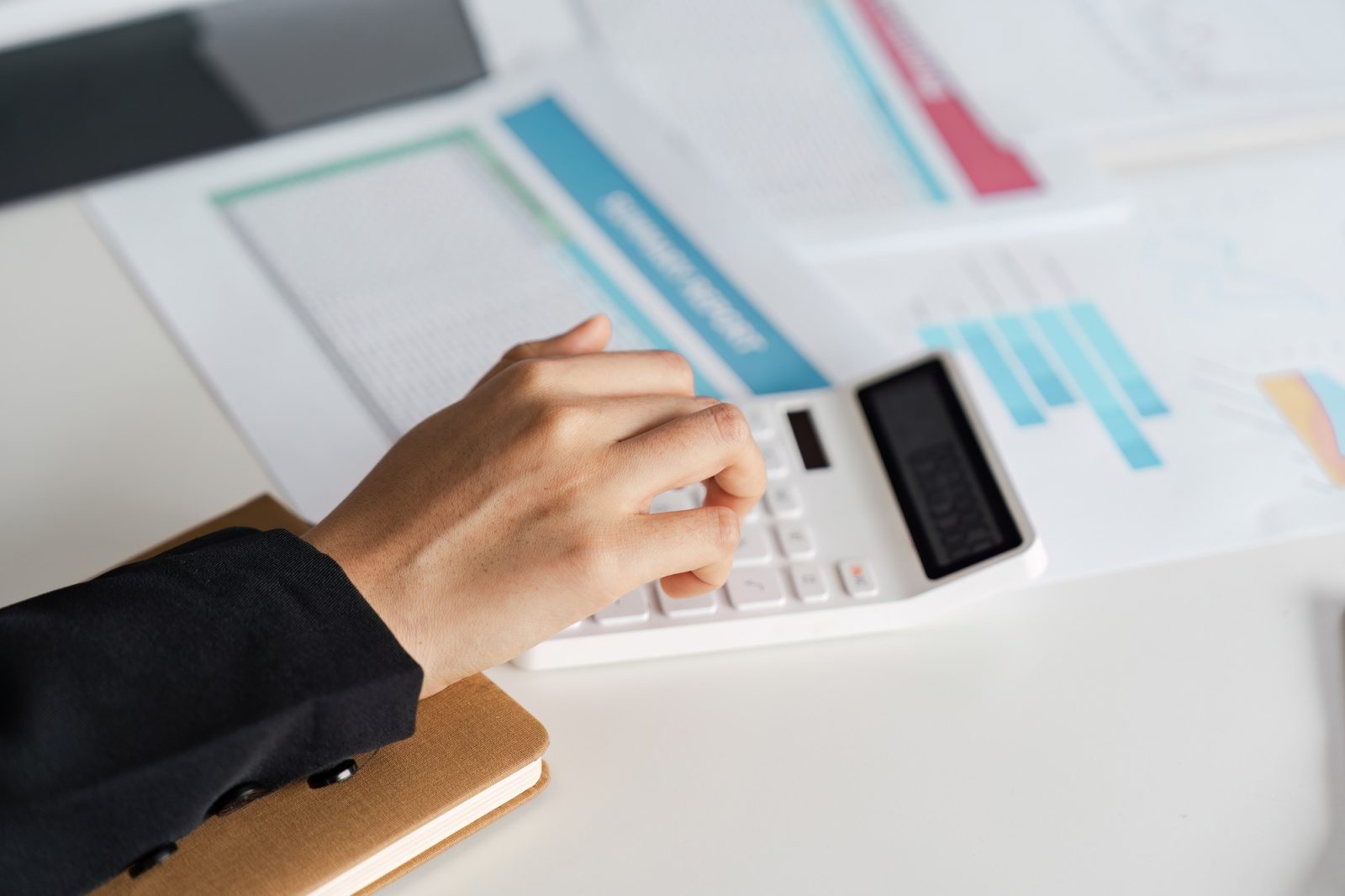 Business Accountant Working with Financial Documents and Calculator in Modern Office Setting